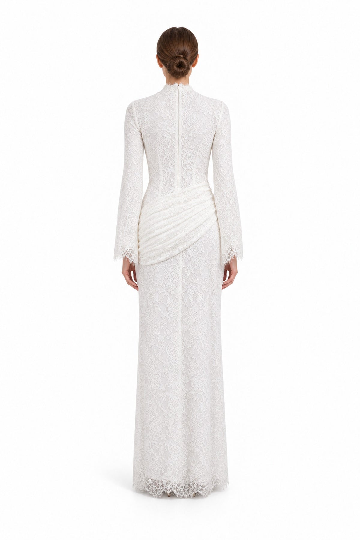 Rear studio view of the Lilia white lace dress, showing the high back, long sleeves and diagonal hip ruching