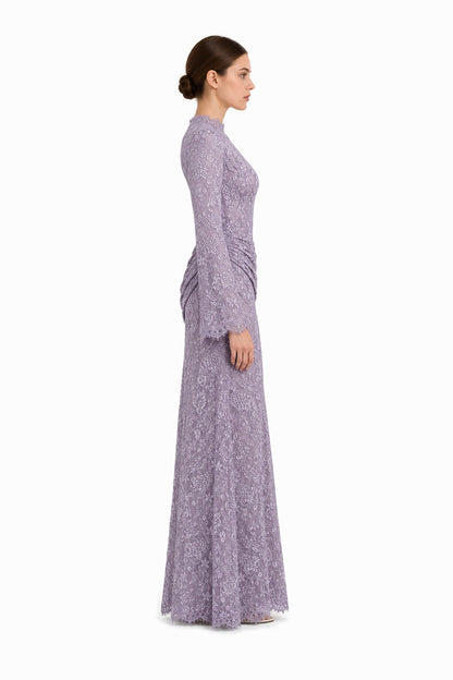 Side studio view of the Lilia lilac lace maxi dress, showing the long sleeve, waist drape and scalloped hem.