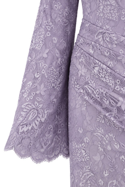 Close-up of the Lilia lilac dress, showing floral lace and the scalloped edge of a long sleeve.