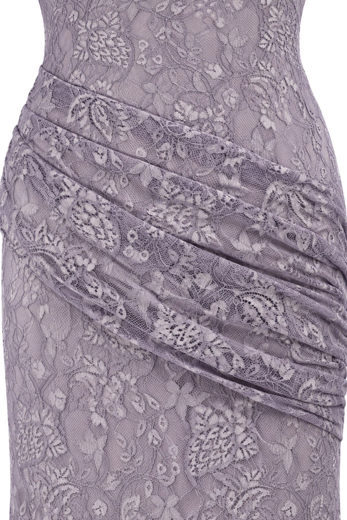 Close-up of the Lilia lilac dress, showing floral lace and the asymmetric draped panel across the waist and hip.